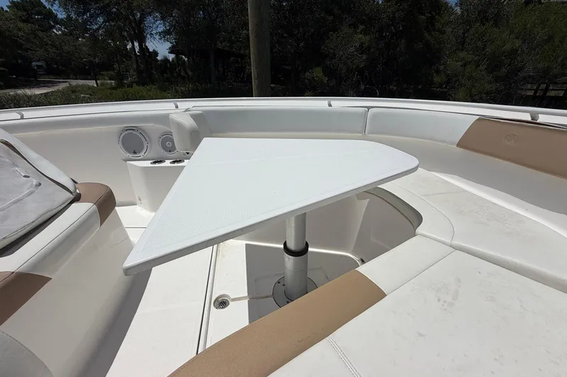 Slide: The Image of 2016 Edgewater 368CC boat interior with seating and a triangular table. - 34