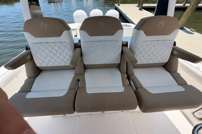 Slide: The Image of Three luxurious seats on a 2016 Edgewater 368CC boat, featuring quilted upholstery. - 36