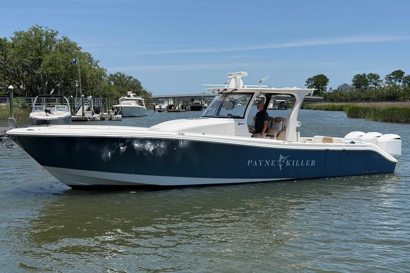 Slide: The Image of 2016 Edgewater 368CC boat on water, featuring sleek design and "Payne Killer" name. - 4