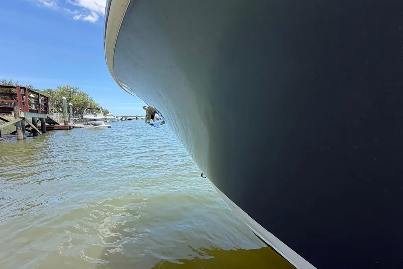 Slide: The Image of 2016 Edgewater 368CC boat docked in a serene marina setting. - 14