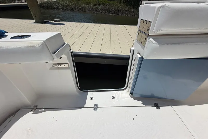 Slide: The Image of 2016 Edgewater 368CC boat interior with open hatch and white seating. - 72