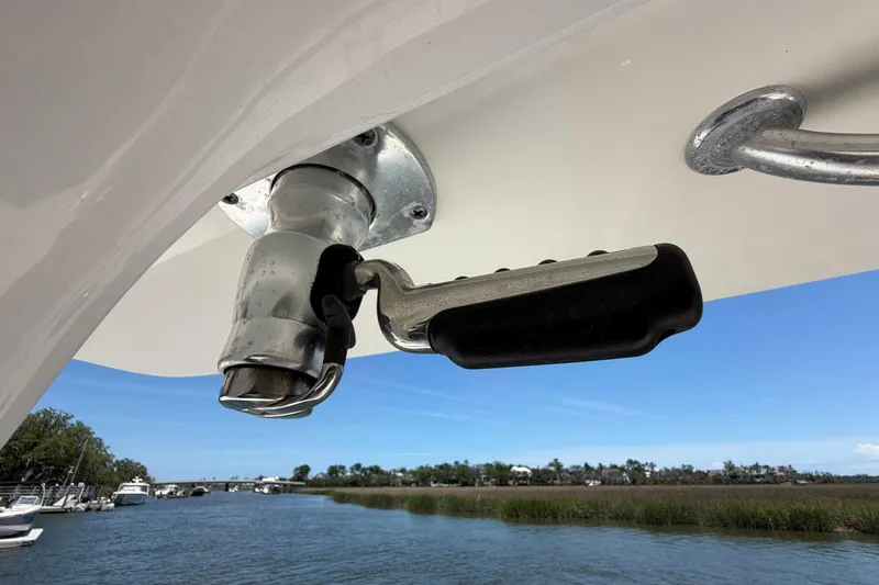 Slide: The Image of Close-up of a 2016 Edgewater 368CC boat handle against a scenic waterway backdrop. - 70