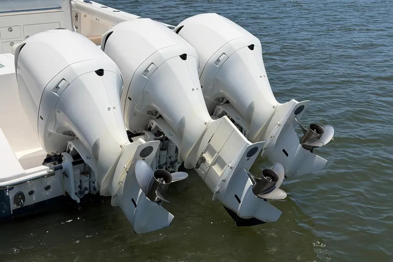 Slide: The Image of Triple outboard motors on a 2016 Edgewater 368CC boat in water. - 15