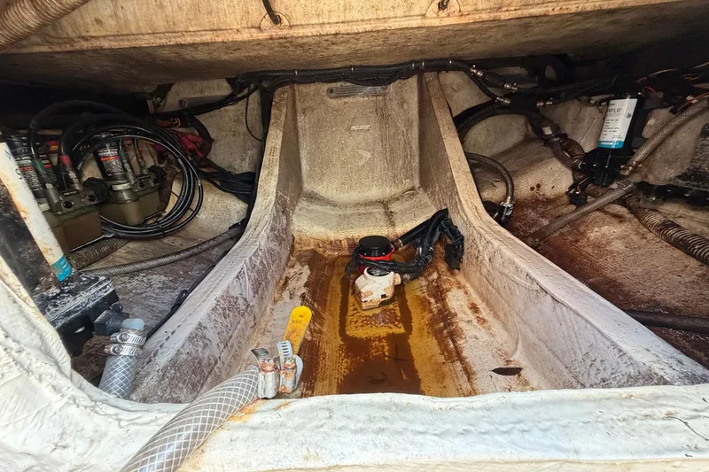 Slide: The Image of Bilge area of a 2016 Edgewater 368CC boat with visible wiring and components. - 74