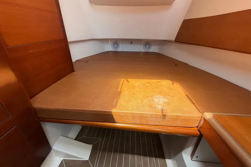 Slide: The Image of 2016 Edgewater 368CC cabin interior with wooden finish and cushioned seating. - 45
