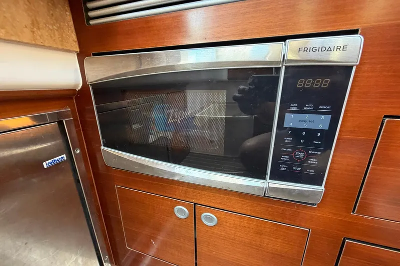 Slide: The Image of Frigidaire microwave in 2016 Edgewater 368CC boat kitchen, featuring wooden cabinetry. - 50