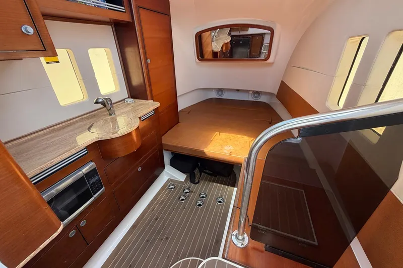 Slide: The Image of Interior of 2016 Edgewater 368CC boat with wood finish and kitchenette. - 42