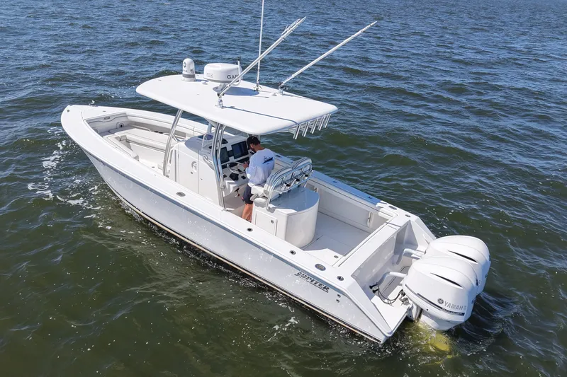 Slide: The Image of 2014 Jupiter 30 FS boat cruising on open water with dual Yamaha engines. - 4