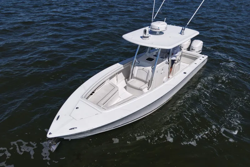 Slide: The Image of 2014 Jupiter 30 FS boat on open water, featuring sleek design and modern equipment. - 9