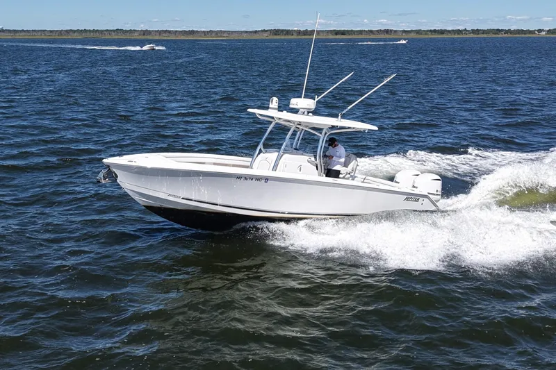 Slide: The Image of 2014 Jupiter 30 FS boat cruising on open water with a person onboard. - 10