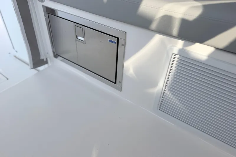 Slide: The Image of 2024 NorthCoast 315 HT interior with stainless steel storage compartment and vent. - 18