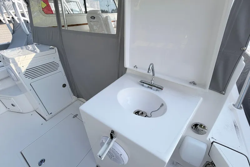 Slide: The Image of 2024 NorthCoast 315 HT boat interior with sink and storage area. - 9