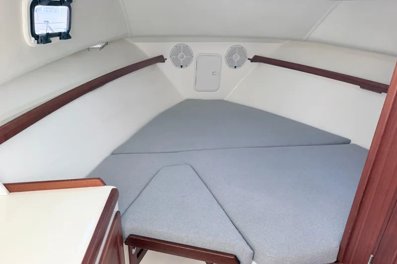 Slide: The Image of 2024 NorthCoast 315 HT cabin interior with cushioned seating and wooden accents. - 20