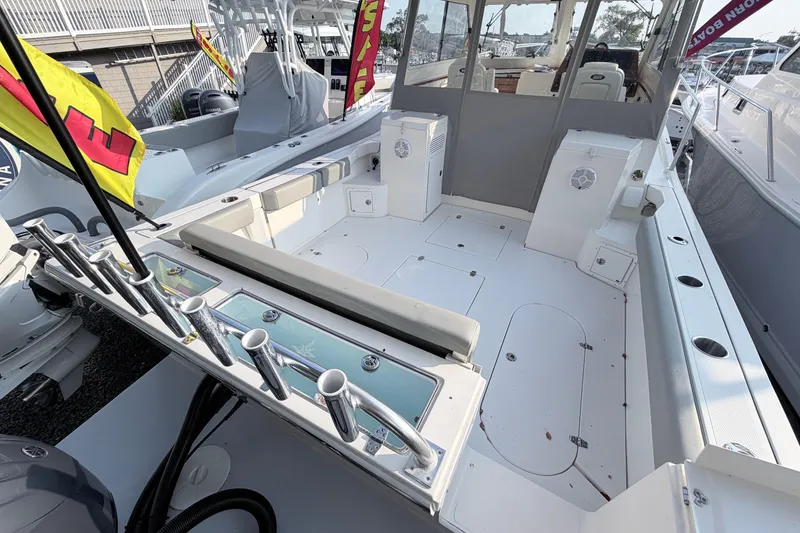 Slide: The Image of 2024 NorthCoast 315 HT boat interior with fishing rod holders and seating area. - 5