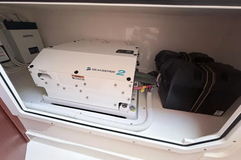 Slide: The Image of 2024 NorthCoast 315 HT boat featuring Seakeeper 2 stabilizer and Xantrex system in compartment. - 24