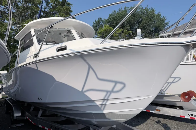 Slide: The Image of 2024 NorthCoast 315 HT boat on trailer, showcasing sleek design and modern features. - 2