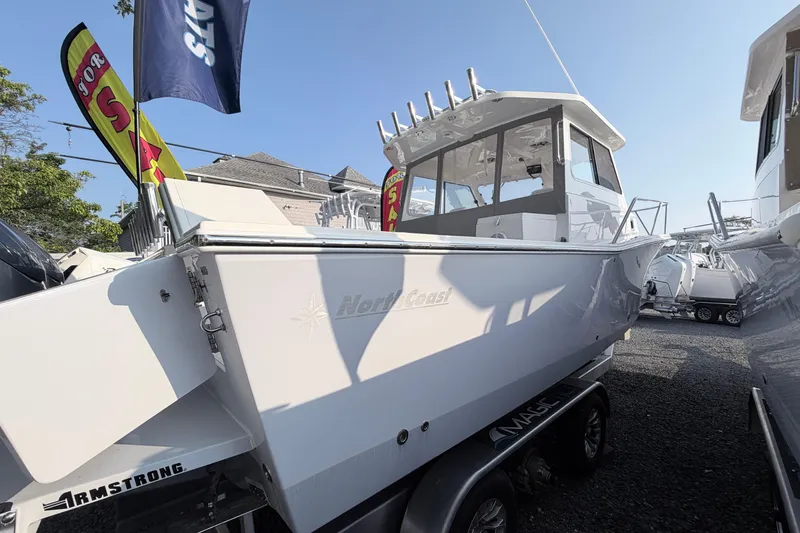 Slide: The Image of 2024 NorthCoast 315 HT boat displayed outdoors on a trailer, under clear blue sky. - 3