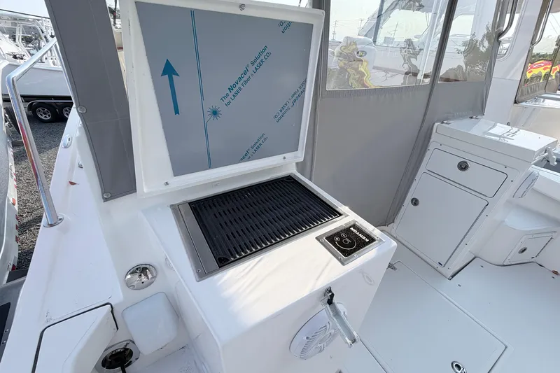 Slide: The Image of 2024 NorthCoast 315 HT boat interior with grill and storage compartments. - 8