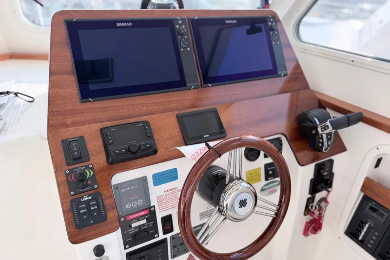 Slide: The Image of 2024 NorthCoast 315 HT helm with dual Simrad displays and modern controls. - 16