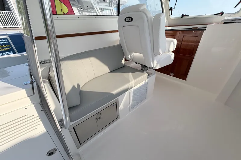 Slide: The Image of 2024 NorthCoast 315 HT boat interior with seating and helm chair. - 15