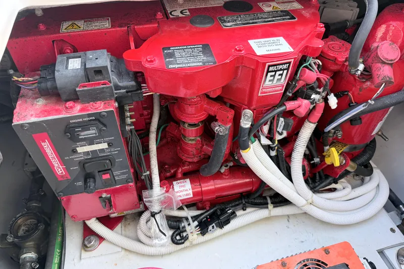Slide: The Image of Engine compartment of 2024 NorthCoast 315 HT boat, featuring red Westerbeke generator. - 12