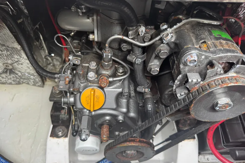 Slide: The Image of Close-up of an engine compartment with various mechanical components and wires. - 16