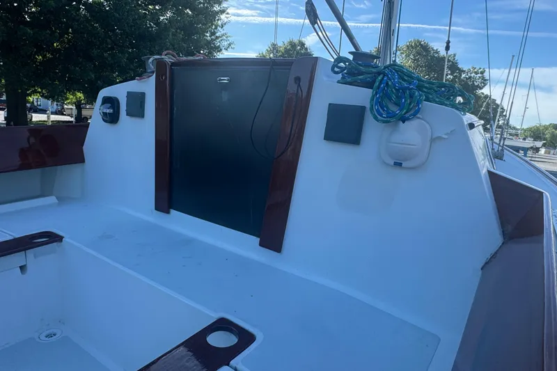 Slide: The Image of Cockpit of a 1995 Alerion 28 sailboat with ropes and wooden trim. - 6