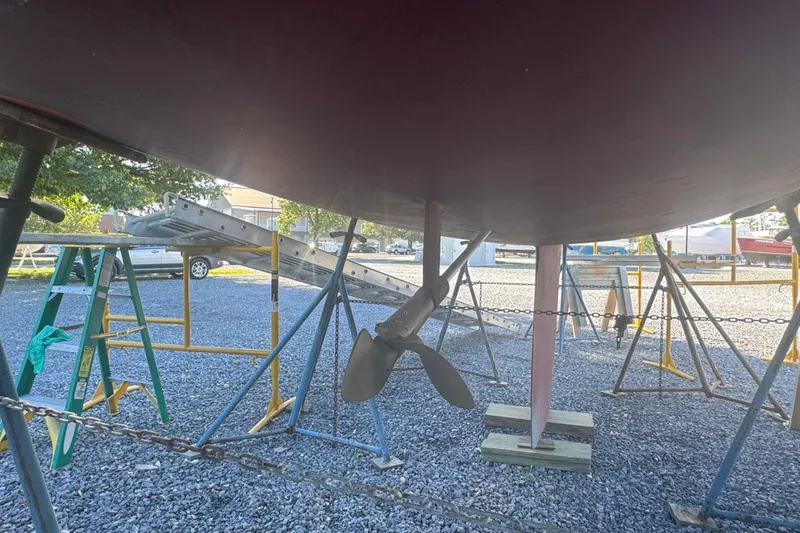 Slide: The Image of Underneath view of a 1995 Alerion 28 sailboat on stands, showing the propeller and keel. - 10