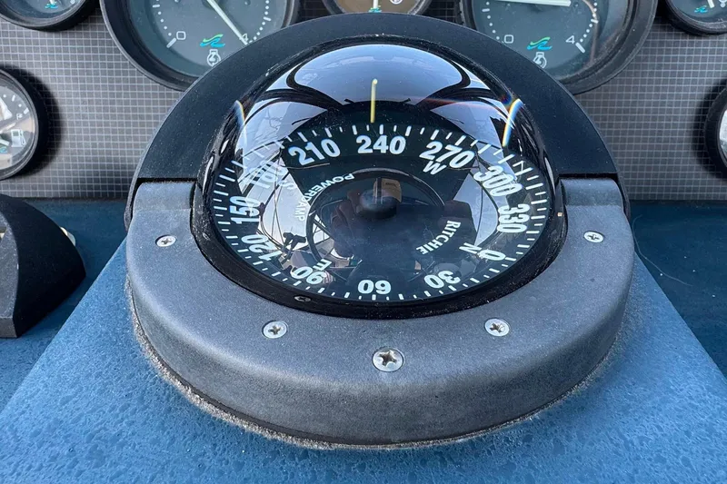Slide: The Image of Compass on 1988 Sea Ray 415 Aft Cabin boat dashboard, showing navigation instruments. - 18