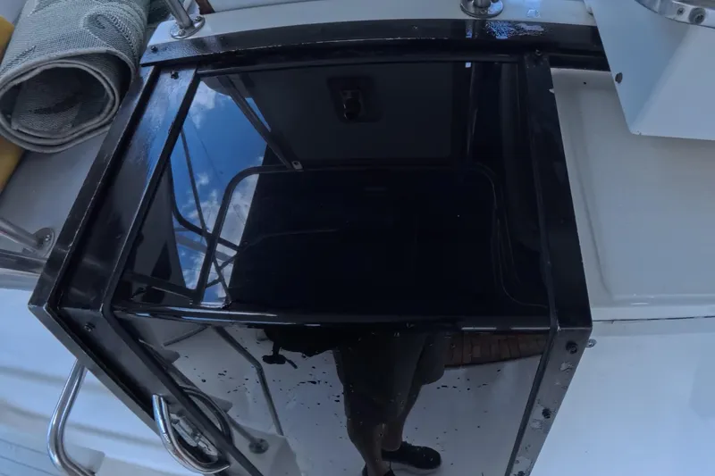 Slide: The Image of 1988 Sea Ray 415 Aft Cabin boat deck with reflective glass and railing. - 29
