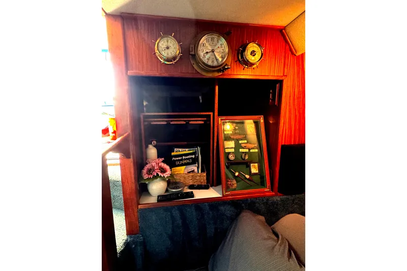 Slide: The Image of 1988 Sea Ray 415 Aft Cabin interior with nautical decor and memorabilia display. - 34
