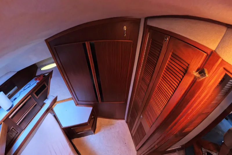 Slide: The Image of 1988 Sea Ray 415 Aft Cabin interior with wooden cabinetry and cozy furnishings. - 56