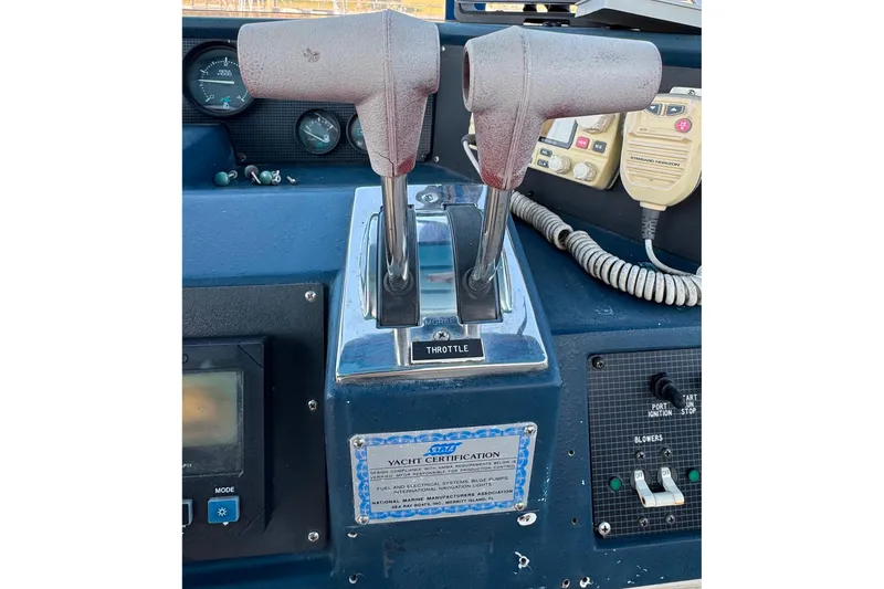 Slide: The Image of Control panel of a 1988 Sea Ray 415 Aft Cabin yacht with throttle levers. - 21