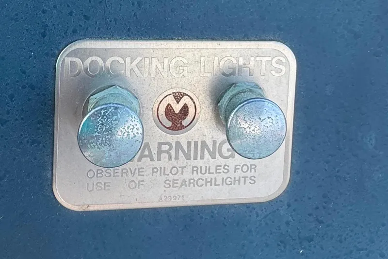 Slide: The Image of Plaque on 1988 Sea Ray 415 Aft Cabin for docking lights, warning about searchlight use. - 24