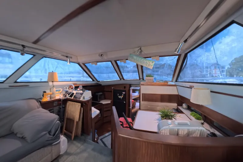 Slide: The Image of Interior of a 1988 Sea Ray 415 Aft Cabin yacht with cozy seating and decor. - 36