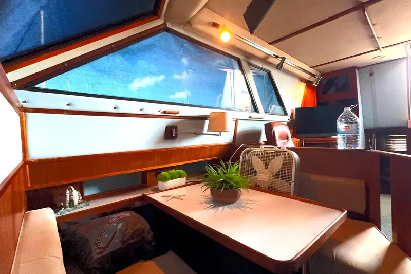 Slide: The Image of Interior of 1988 Sea Ray 415 Aft Cabin with dining area and large windows. - 46