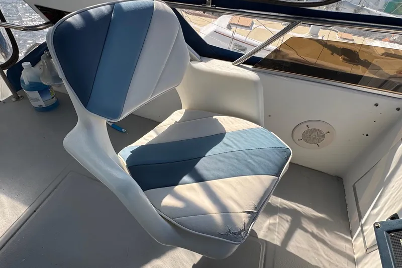 Slide: The Image of Captain's chair on 1988 Sea Ray 415 Aft Cabin boat, featuring blue and white upholstery. - 15