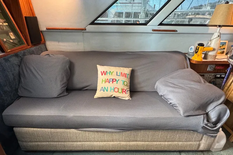 Slide: The Image of 1988 Sea Ray 415 Aft Cabin interior with cozy sofa and colorful pillow. - 30