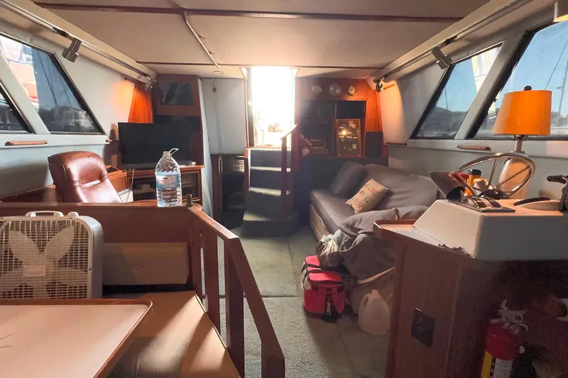 Slide: The Image of Interior of a 1988 Sea Ray 415 Aft Cabin yacht, featuring cozy seating and nautical decor. - 37