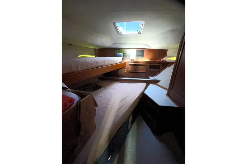 Slide: The Image of 1988 Sea Ray 415 Aft Cabin interior with cozy sleeping quarters and natural light. - 55