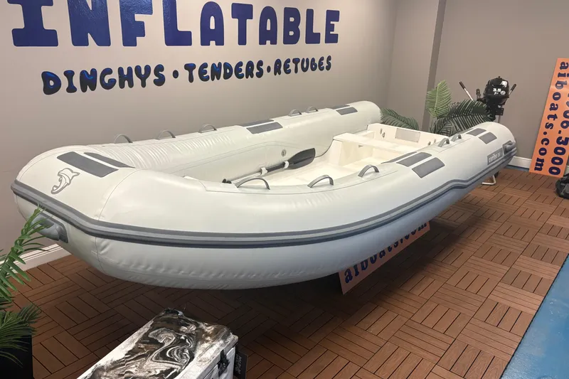 Slide: The Image of Inflatable Caribe C-14 dinghy, 2026 model, displayed indoors with promotional signage. - 5