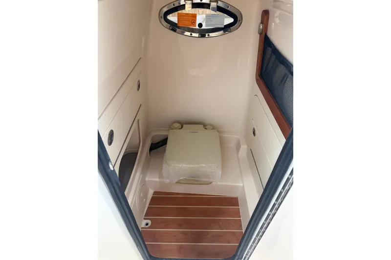 Slide: The Image of Interior of 2025 Grady-White Fisherman 216 boat, featuring compact cabin space. - 21