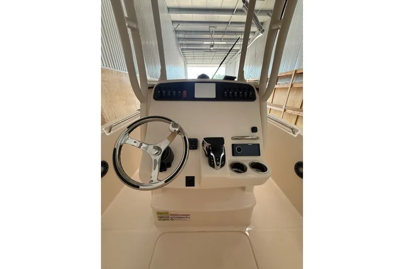 Slide: The Image of 2025 Grady-White Fisherman 216 boat console with steering wheel and controls. - 19