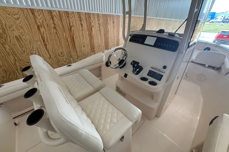 Slide: The Image of 2025 Grady-White Fisherman 216 boat interior with steering console and cushioned seating. - 17
