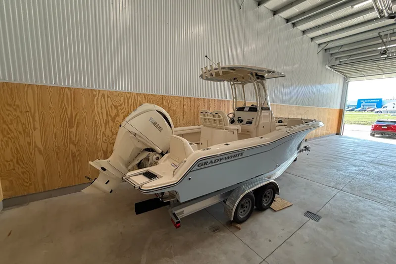 Slide: The Image of 2025 Grady-White Fisherman 216 boat in a garage, featuring Yamaha outboard motor. - 7