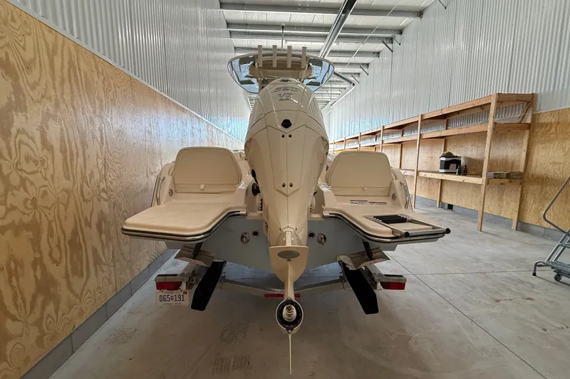 Slide: The Image of 2025 Grady-White Fisherman 216 boat in storage, rear view showing seating and motor. - 10