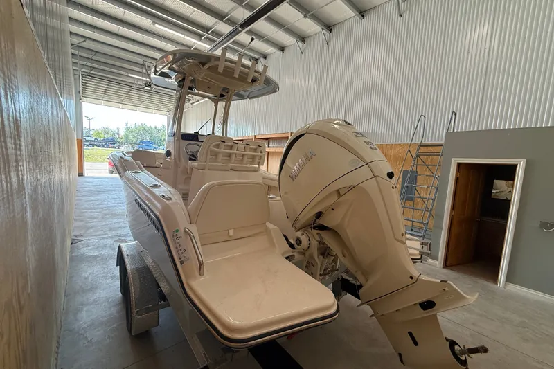 Slide: The Image of 2025 Grady-White Fisherman 216 boat in storage, featuring Yamaha outboard motor. - 11