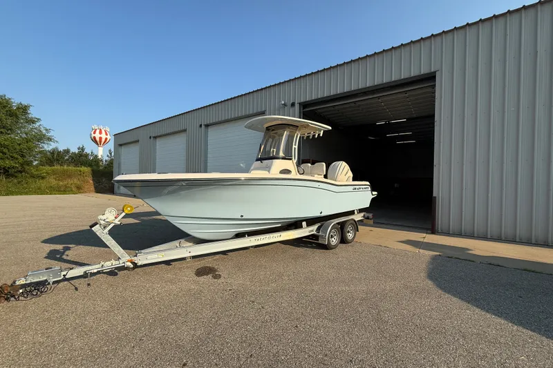 The Image of 2025 Grady-White Fisherman 216 boat on trailer outside metal warehouse. - 0