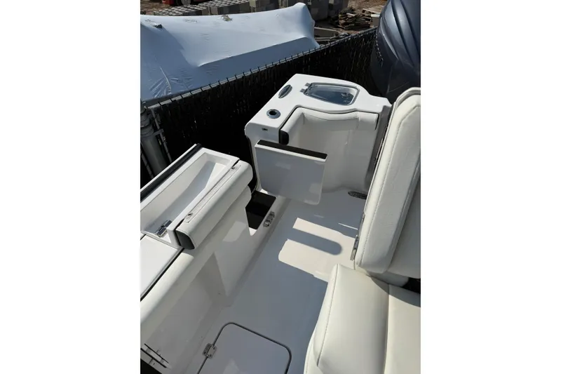 Slide: The Image of 2026 Tidewater 256 CC Adventure boat interior with seating and storage compartments. - 8