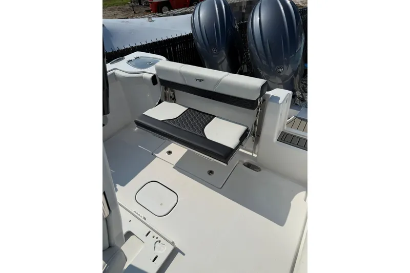 Slide: The Image of 2026 Tidewater 256 CC Adventure boat interior with seating and dual engines. - 10